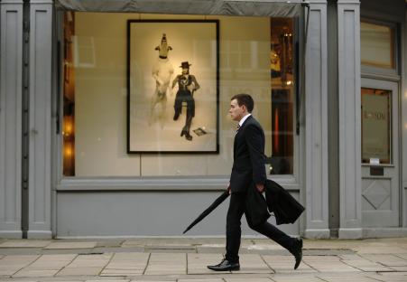 © Reuters/Luke MacGregor. A man passes a gallery in London, March 25, 2014.
