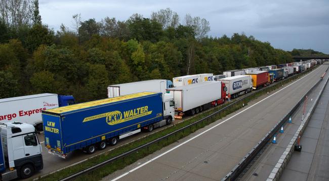© Bloomberg. ASHFORD, ENGLAND - SEPTEMBER 24: Lines of heavy goods vehicles and cargo lorries are seen queued along the M20 motorway as part of the Operation Stack traffic control plan, on September 24, 2020 near Ashford, England. Due to industrial action in Calais, vehicles were backed up along the motorway to prevent overcrowding and gridlock in the port of Dover. (Photo by Leon Neal/Getty Images)