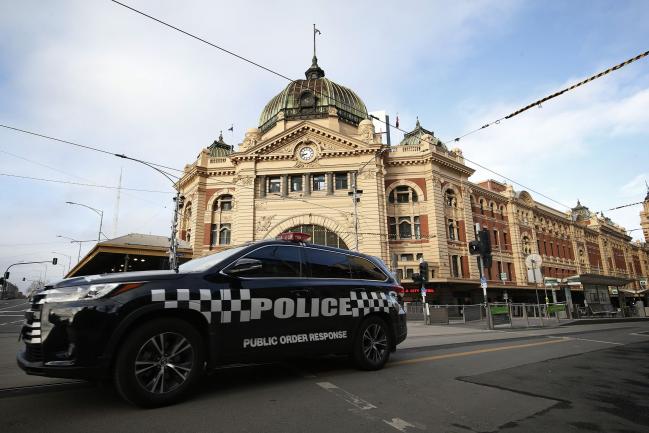 © Bloomberg. MELBOURNE, AUSTRALIA - AUGUST 09: Police patrol in the city on August 09, 2020 in Melbourne, Australia. Protesters face fines and arrest for breaching the Chief Health Officer's directives as Victoria works to contain COVID-19 transmissions in the community. Melbourne's current lockdown restrictions and Metropolitan Melbourne is under stage 4 lockdown restrictions, with people only allowed to leave home to give or receive care, shopping for food and essential items, daily exercise and work while an overnight curfew from 8pm to 5am is also in place. The majority of retail businesses are also closed. Other Victorian regions are in stage 3 lockdown. The restrictions, which came into effect from 2 August, have been introduced by the Victorian government as health authorities work to reduce community COVID-19 transmissions across the state. (Photo by Darrian Traynor/Getty Images)