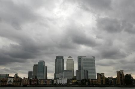 © Reuters/Greg Bos. Storm clouds are seen above the Canary Wharf financial district in London on Aug. 3, 2010.