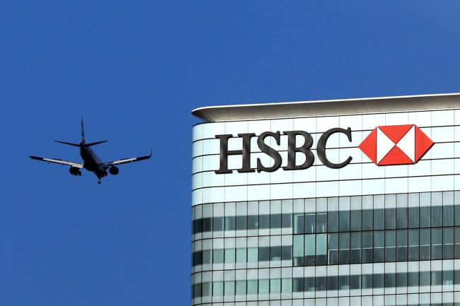 © Bloomberg. An aeroplane approaches city airport passing the offices of HSBC Holdings Plc in the Canary Wharf business, financial and shopping district in London, U.K., on Thursday, June 5, 2018. The owners of a Canary Wharf skyscraper leased to Citigroup Inc. are seeking to refinance the 661 million-pound ($882 million) loan used to buy it five years ago, two people with knowledge of the plan said. Photographer: Chris Ratcliffe/Bloomberg