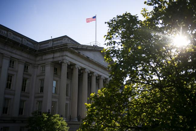 © Bloomberg. An American flag flies above the U.S. Treasury building in Washington, D.C., U.S., on Thursday, April 16, 2020. President Donald Trump threatened Wednesday to try to force both houses of Congress to adjourn -- an unprecedented move that would likely raise a constitutional challenge -- so that he can make appointments to government jobs without Senate approval. Photographer: Al Drago/Bloomberg