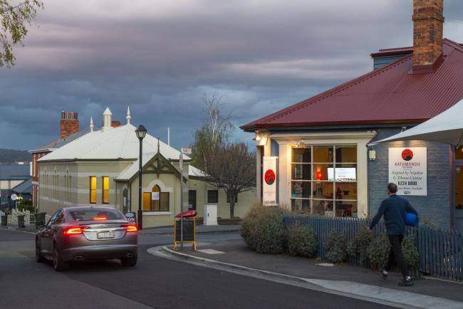 © Bloomberg. A car passes a restaurant at Battery Point in Hobart, Tasmania, Australia, on Monday, Sept. 21, 2020. Tasmania has virtually eliminated the coronavirus by cutting itself off from the mainland. But the economic cost for the island, where almost 1 in 5 jobs is reliant on tourism, is mounting. Photographer: Chris Crerar/Bloomberg