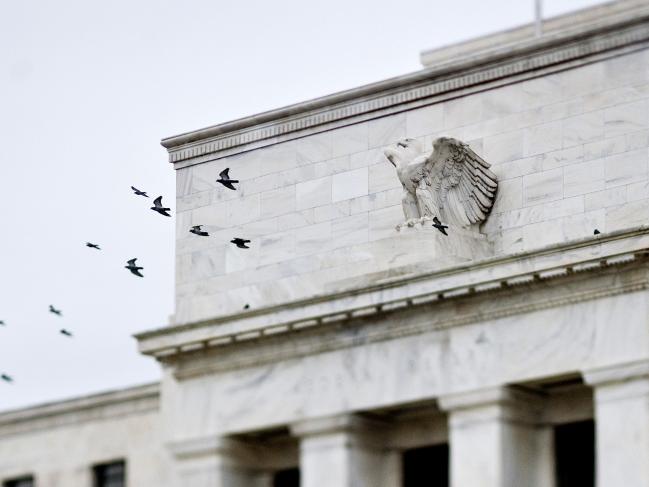 © Bloomberg. Birds fly past the Marriner S. Eccles Federal Reserve Board building in Washington, D.C. Photographer: Joshua Roberts/Bloomberg