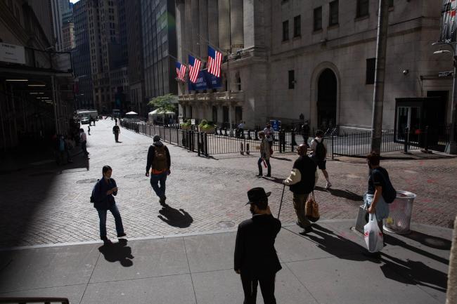 © Bloomberg. Pedestrians pass in front of the New York Stock Exchange (NYSE) in New York, U.S., on Friday, Oct. 2, 2020. New York faced pressure as middle and high schools reopened, infection rates in virus hot spots rose further and the city's bond rating was cut by Moody's.