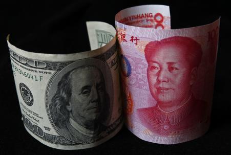 © REUTERS/Petar Kujundzic. A 100 yuan banknote (R) is placed next to a 0 banknote in this picture illustration taken in Beijing November 7, 2010.