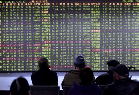 © Getty Images/AFP. Chinese shares closed down more than 5 percent on Nov. 27, 2015, after inquiries were announced into several major brokerage firms. In this photo, investors sit in front of a screen showing stock market movements in a stock firm in Hangzhou, east China's Zhejiang province on Nov. 27, 2015.