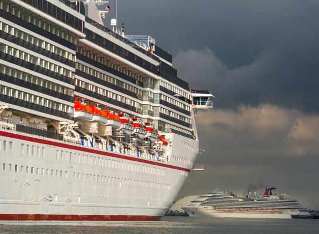 © Bloomberg. The Carnival Corp. Miracle and Panorama cruise ships sit acnhored at the Port of Long Beach in Long Beach, California, U.S., on Monday, April 13, 2020. The Centers for Disease Control and Prevention extended its “No Sail Order” for all cruise ships by at least 100 days -- or until Covid-19 is no longer considered a public health emergency.