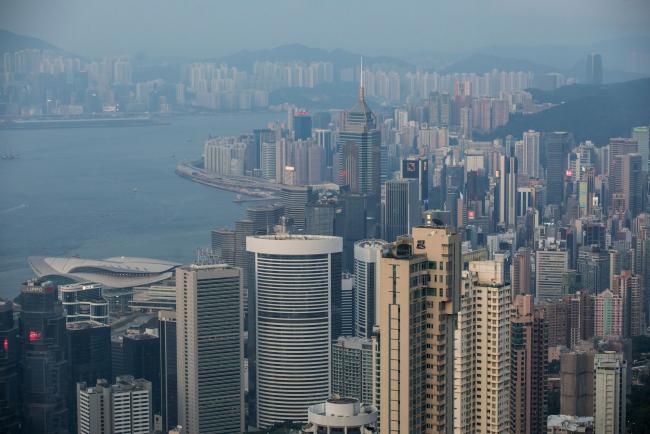 © Bloomberg. Buildings are seen from Victoria Peak in Hong Kong, China, on Wednesday, Aug. 28, 2019. Hong Kong's hotel industry is struggling with a collapse in bookings after thousands of protesters shut down flights from the territory's airport in an escalation of months of clashes with police. Photographer: Paul Yeung/Bloomberg