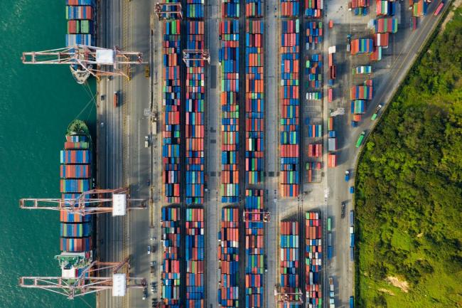© Bloomberg. Container ships are docked as shipping containers sit in the Busan Port Terminal (BPT) in this aerial photograph taken in Busan, South Korea, on Tuesday, Oct. 13, 2020. South Korea’s central bank left its key interest rate unchanged on Wednesday amid signs that a resurgence of the coronavirus at home is waning and exports and inflation are picking up. Photographer: SeongJoon Cho/Bloomberg