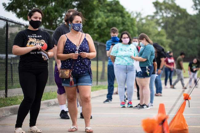 © Bloomberg. DALLAS, TX - JUNE 27: Patients wait in line at a walk up COVID-19 testing site at A+ Academy Secondary School on June 27, 2020 in Dallas, Texas. Texas is facing a surge of new cases of COVID-19 after the state government allowed business to open prematurely. (Photo by Montinique Monroe/Getty Images)