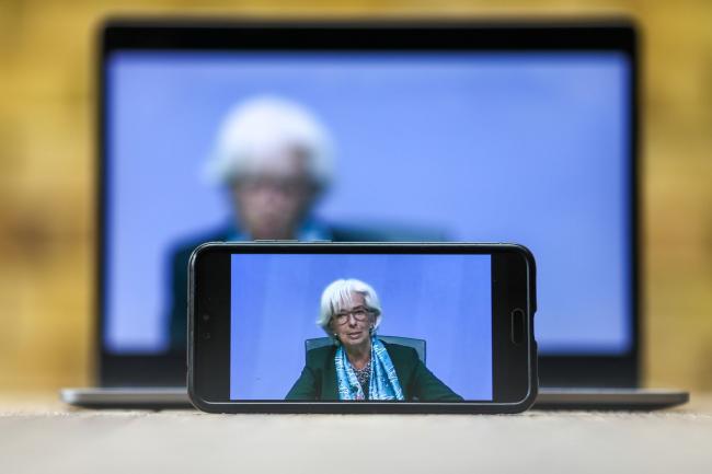 © Bloomberg. Christine Lagarde, president of the European Central Bank (ECB), is displayed on a mobile phone and laptop computer during a live stream video of the central bank's virtual rate decision news conference in Frankfurt, Germany, in this arranged photograph in London, U.K., on Thursday, June 4, 2020. The ECB intensified its response to the coronavirus recession with a bigger-than-anticipated increase to its emergency bond-buying program.