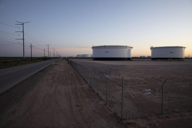 © Bloomberg. Crude oil storage tanks stand outside Midland, Texas, U.S, on Friday, April 24, 2020. The price for the U.S. benchmark for crude oil, West Texas Intermediate, dropped below zero for the first time in history this month amid a global oil glut. Photographer: Matthew Busch/Bloomberg