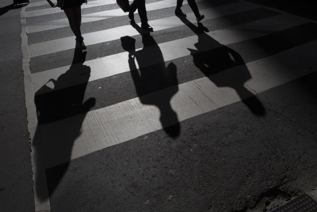 © Bloomberg. The shadow of pedestrians are seen on the ground of a crosswalk in Toronto, Ontario, Canada, on Friday, May 19, 2017. Ontario is easing rules for its pension funds as years of low interest rates, poor equity returns and a looming retiree glut pressure companies. Photographer: Brent Lewin/Bloomberg