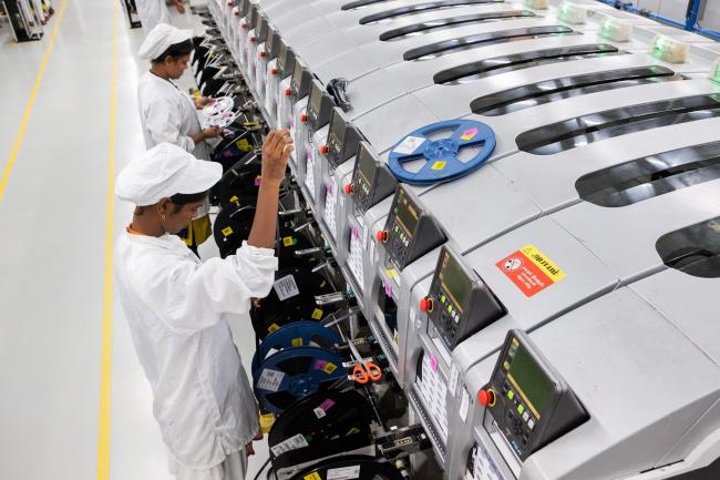 &copy Bloomberg. Employees work in a factory at the mobile phone plant of Rising Stars Mobile India Pvt., a unit of Foxconn Technology Co., in Sriperumbudur, Tamil Nadu, India, on Friday, July 12, 2019. Foxconn, also known as Hon Hai Precision Industry Co., opened its first India factory four years ago, it now operates two assembly plants with plans to expand those and open two more. The company was integral to China’s transformation into a manufacturing colossus, and founder Terry Gou has told India's Prime Minister Narendra Modi that Foxconn could help India do the same. Photographer: Karen Dias/Bloomberg