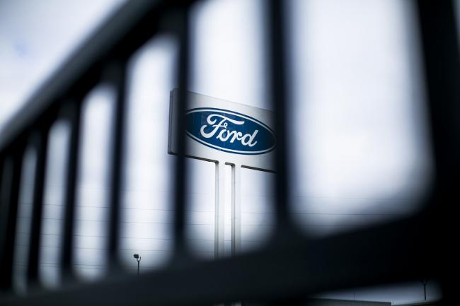 © Bloomberg. Signage is displayed outside the idled Ford Motor Co. Michigan Assembly plant in Wayne, Michigan, U.S., on Monday, March 23, 2020. The auto industry is escalating its push for U.S. assistance to help weather the impact of a global pandemic that has halted or will soon stop production at 42 out of 44 plants that assemble vehicles in the country. Photographer: Anthony Lanzilote/Bloomberg