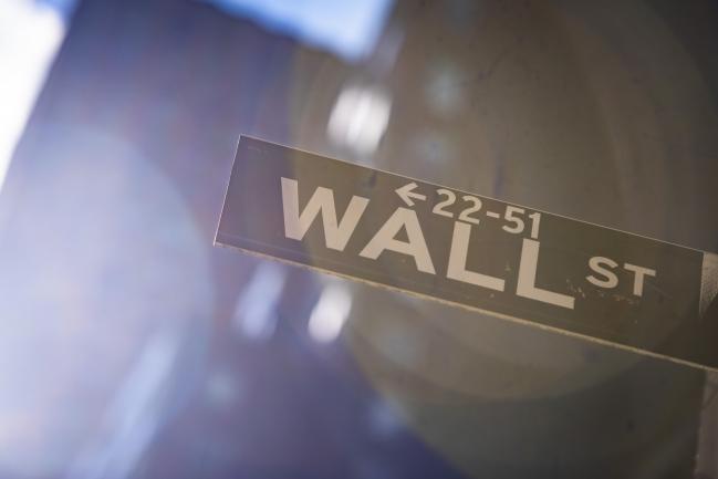 © Bloomberg. A Wall Street sign is displayed in front of New York Stock Exchange (NYSE) in New York, U.S., on Friday, March 13, 2020. Photographer: Mark Kauzlarich/Bloomberg