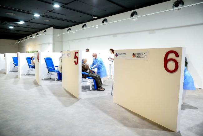 © Bloomberg. A health worker administers the Moderna Inc. Covid-19 vaccine to a visitor at a Covid-19 vaccination center in Rome, Italy, on Wednesday, March 17, 2021. Europe's biggest countries, including Germany and France, suspended use of AstraZeneca Plc's Covid-19 vaccine amid a growing health scare that's creating yet another delay for the European Union's inoculation campaign.