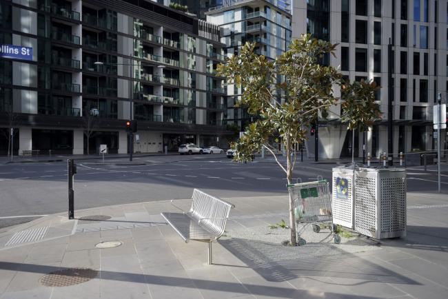 © Bloomberg. A shopping cart is left abandoned on a deserted street in the Docklands area of Melbourne on July 9.