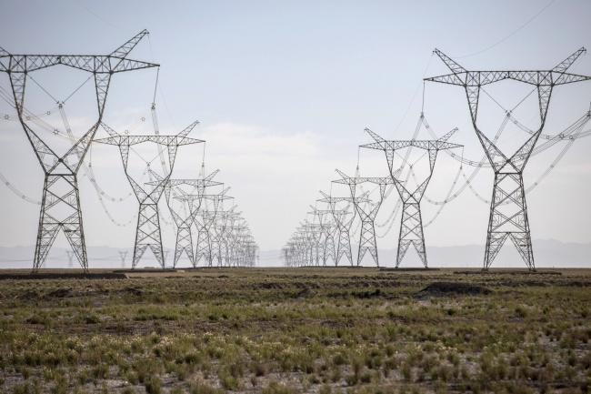 © Bloomberg. Power lines carrying electricity from the Golmud Solar Park hang from transmission towers on the outskirts of Golmud, Qinghai province, China, on Wednesday, July 25, 2018. China has emerged as the global leader in clean power investment after it spent $127 billion in renewable energy last year as it seeks to ease its reliance on coal and reduce smog in cities, according to a report jointly published by the United Nations and Bloomberg New Energy Finance in April. Photographer: Qilai Shen/Bloomberg