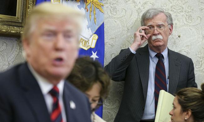 © Bloomberg. John Bolton listens as Donald Trump speaks in the Oval Office of the White House in Washington, D.C., on May 22, 2018. Photographer: Oliver Contreras/Bloomberg
