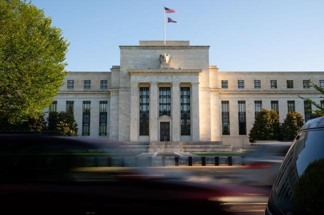 © Bloomberg. Traffic passes the Marriner S. Eccles Federal Reserve building in Washington, D.C., U.S., on Tuesday, Aug. 18, 2020. In addition to helping rescue the U.S. economy amid the coronavirus pandemic, Fed Chair Jerome Powell and colleagues also spent 2020 finishing up the central bank’s first-ever review of how it pursues the goals of maximum employment and price stability set for it by Congress.