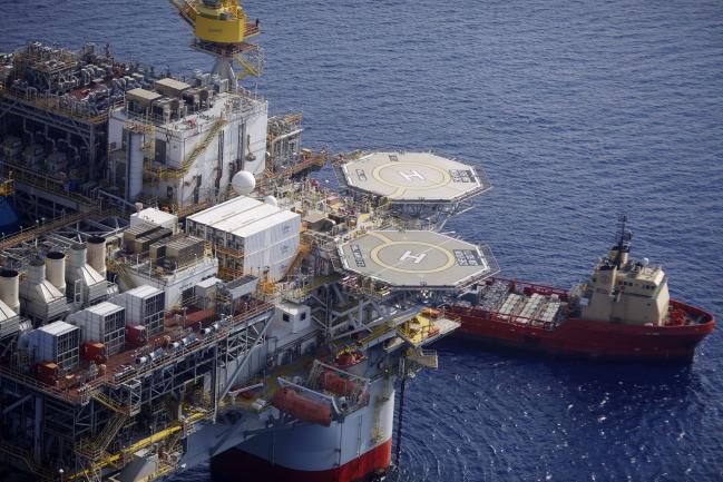 © Bloomberg. The Kobe Chouest platform supply vessel sits anchored next to the Chevron Corp. Jack/St. Malo deepwater oil platform in the Gulf of Mexico in the aerial photograph taken off the coast of Louisiana, U.S., on Friday, May 18, 2018. While U.S. shale production has been dominating markets, a quiet revolution has been taking place offshore. The combination of new technology and smarter design will end much of the overspending that's made large troves of subsea oil barely profitable to produce, industry executives say. Photographer: Luke Sharrett/Bloomberg