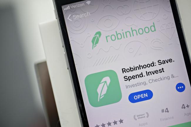 © Bloomberg. The Robinhood application is displayed in the App Store on an Apple Inc. iPhone in an arranged photograph taken in Washington, D.C., U.S., on Friday, Dec. 14, 2018. The Securities Investor Protection Corp. said a new checking account from Robinhood Financial LLC raises red flags and that the deposited funds may not be eligible for protection. Photographer: Andrew Harrer/Bloomberg