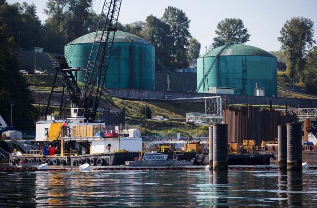 © Bloomberg. Oil storage tanks sit at the Kinder Morgan Inc. Westridge Marine Terminal during an emergency response exercise in Burnaby, British Columbia, Canada, on Wednesday, Sept. 19, 2018. A Canadian court's decision to nullify approval of the Trans Mountain Expansion Project will increase crude-by-rail transport in the near term and will likely have a 
