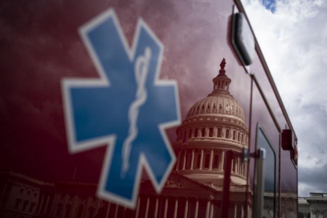 © Bloomberg. The U.S. Capitol is reflected on an ambulance in Washington, D.C., U.S., on Thursday, April 9, 2020.