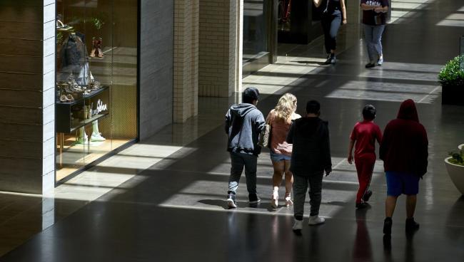 © Bloomberg. Shoppers walk through NorthPark Center mall in Dallas on May 1.