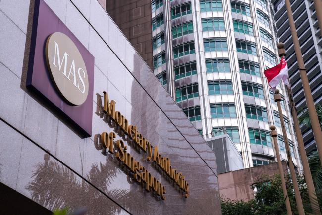 © Bloomberg. Signage for the Monetary Authority of Singapore (MAS) is displayed outside the central bank's headquarters in Singapore, on Tuesday, Oct. 22, 2019. Singapore's economy may be a few quarters away from a recovery as the decline in trade and manufacturing this year hasn't really spread to other sectors, the central bank's chief said.