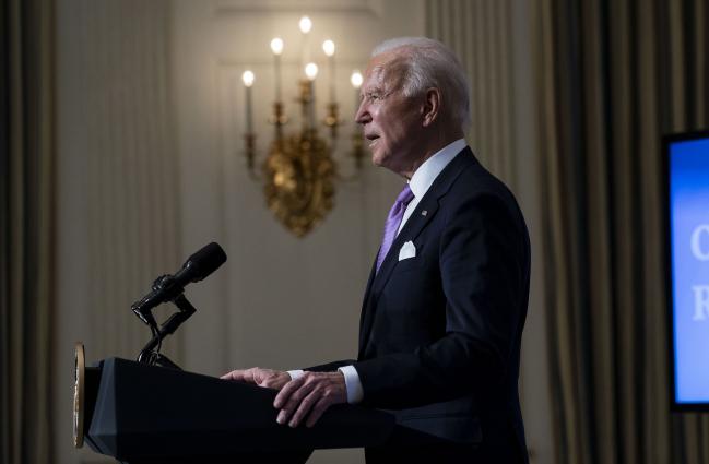 © Bloomberg. WASHINGTON, DC - JANUARY 26: U.S. President Joe Biden speaks about the coronavirus pandemic in the State Dining Room of the White House on January 26, 2021 in Washington, DC. President Biden said his administration has secured commitments from vaccine makers Pfizer and Moderna to purchase another 200 million doses that will arrive this summer. (Photo by Doug Mills-Pool/Getty Images)