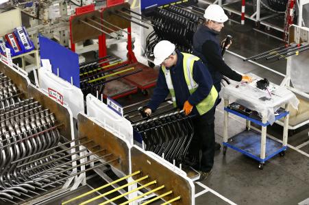 © Reuters/Darren Staples. Workers inspect components on the fuel inlet production facility at Futaba Industrial in Foston, central England, Jan. 21, 2014.