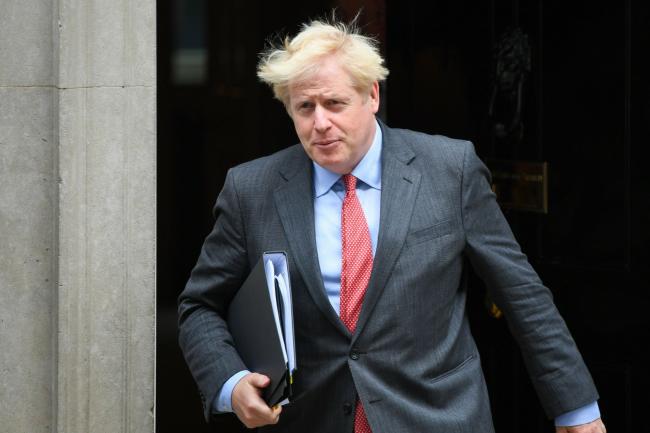 © Bloomberg. Boris Johnson, U.K. prime minister, departs from number 10 Downing Street on his way to make a statement in Parliament in London, U.K., on Tuesday, Sept. 22, 2020. Former U.K. Prime Minister Theresa May slammed Boris Johnson's plan to break international law over Brexit, and said she won’t vote for it in Parliament.