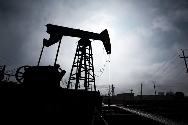 © Bloomberg. A pumpjack is silhouetted as it operates in Baku, Azerbaijan, on Sunday, March 18, 2018. Two years after descending into junk, Azerbaijan's shortest path to winning back its investment grade is by rebuilding the stash of petrodollars it raided during a recession and a banking meltdown, according to Fitch Ratings. Photograph: Taylor Weidman/Bloomberg Photographer: Taylor Weidman/Bloomberg