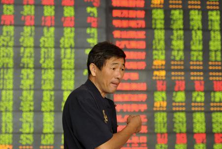 © Reuters/Stringer. China stocks fell more than 3 percent Monday morning as lingering concerns over the economy offset optimism that reform among state-owned enterprises would accelerate. Pictured: An investor spoke in front of an electronic board showing stock information at a brokerage house in Fuyang, Anhui province, China, Sept. 14, 2015.