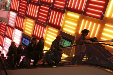 © Reuters/Andrew Kelly. People ride an escalator at the Toys R Us Times Square store during the early opening of the Black Friday sales in the Manhattan borough of New York Nov. 27, 2015.