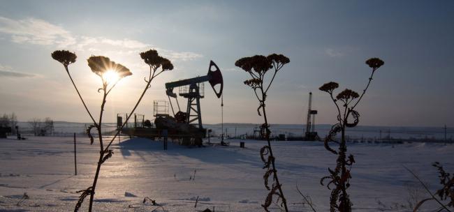 © Bloomberg. An oil pumping jack, also known as a 'nodding donkey,' operates in a snow covered oilfield in the village of Otrada, 150kms from Ufa, Russia.