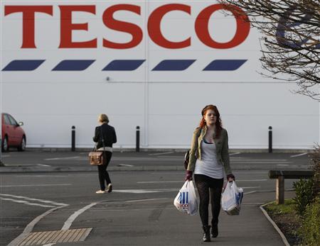 © Darren Staples/Reuters. A shopper leaves a Tesco store in Loughborough, U.K., Jan. 12, 2012.