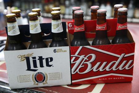 © Getty Images/Joe Raedle. Brewing giant Anheuser-Busch InBev on Wednesday raised its bid for SABMiller Plc, the world's second-largest brewer. In this photo illustration, bottles of Budweiser and Miller Lite beer are seen on September 16, 2015 in Miami, Florida.