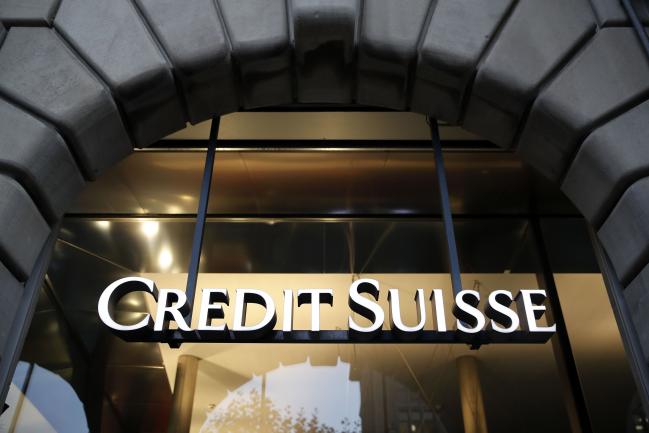 © Bloomberg. A Credit Suisse logo hangs in the entrance to a Credit Suisse Group AG bank branch in Zurich, Switzerland, on Wednesday, Oct. 30, 2019. Credit Suisse’s third-quarter results were boosted by gains at the key trading unit, bringing relief to Chief Executive Officer Tidjane Thiam as he seeks to emerge from a spying scandal that dented the bank’s reputation and cost him a key lieutenant. Photographer: Stefan Wermuth/Bloomberg