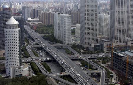 © Reuters/Jason Lee. Vehicles drive on the Guomao Bridge through Beijing's central business district on June 11, 2015. The World Bank said on July 1, 2015, that it expects China's economy to grow 7.1 percent this year, the same as forecast earlier, before cooling to 7.0 percent next year and 6.9 percent in 2017. The country clocked a 'stable' growth rate of 7 percent in the second quarter of 2015, according to official data released Wednesday.