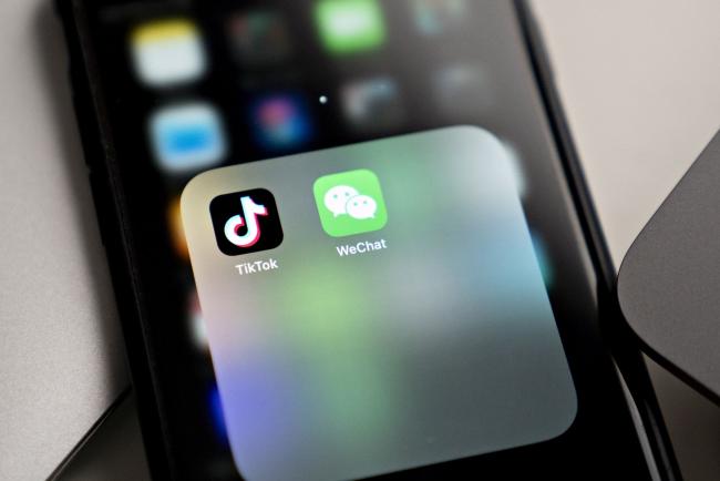 © Bloomberg. The Tencent Holdings Ltd. WeChat and ByteDance Ltd. TikTok app icons are displayed on a smartphone in an arranged photograph taken in Arlington, Virginia, U.S., on Friday, Aug. 7, 2020. President Donald Trump signed a pair of executive orders prohibiting U.S. residents from doing business with the Chinese-owned TikTok and WeChat apps beginning 45 days from now, citing the national security risk of leaving Americans' personal data exposed. Photographer: Andrew Harrer/Bloomberg