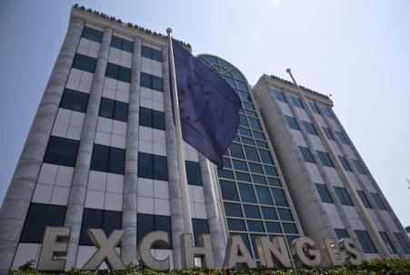 © Reuters/Ronen Zvulun. Investors are bracing for a 20 percent plunge when the Athens stock sxchange reopens Monday. Pictured: A European Union flag flutters outside the Athens stock exchange, July 27, 2015.