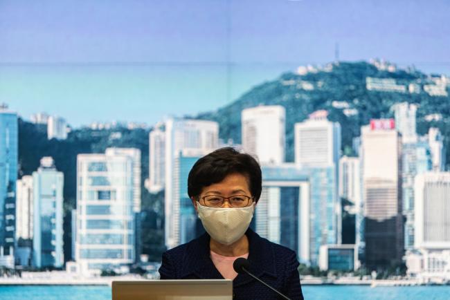 © Bloomberg. Carrie Lam, Hong Kong's chief executive, speaks during a news conference in Hong Kong, China, on Friday, July 31, 2020. Hong Kong’s government will delay upcoming legislative elections, Lam said at a news conference on Friday evening.