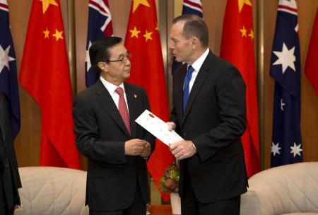 © Reuters/Penny Bradfield. China and Australia on Wednesday signed what both countries termed a landmark trade deal. In this photo, Australian Prime Minister Tony Abbott (R) talks with China's Minister of Commerce Gao Hucheng during an official meeting in Canberra on June 17, 2015.