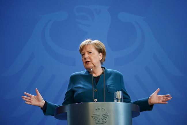 © Bloomberg. BERLIN, GERMANY - MARCH 22: German Chancellor Angela Merkel speaks to the media to announce further measures to combat the spread of the coronavirus and COVID-19, the disease the virus causes, after she held a teleconference with the governors of Germany's 16 states on March 22, 2020 in Berlin, Germany. Following her speech, Merkel went home to quarantine after a doctor she was in contact with tested positive for coronavirus. The Chancellor during her speech announced the country will ban gatherings of more than two people, with the exception of families and households, as a measure to combat the spread of the virus that has so far caused over 23,000 infections and 92 deaths. (Photo by Clemens Bilan - Pool/Getty Images)