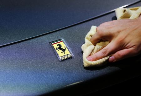 © Reuters/Kai Pfaffenbach. Ferrari NV filed papers Friday for an initial public offering (IPO) in the United States, which could be launched as early as mid-October, and could value the luxury carmaker at .82 billion. In this photo, an employee polishes the front of a Ferrari car during the media day at the Frankfurt Motor Show (IAA) in Frankfurt, Germany, on Sept. 14, 2015.