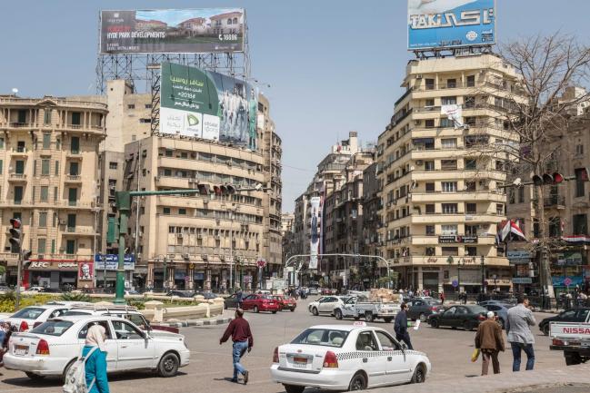 © Bloomberg. Advertisements for real estate developments sit on a building on Tahrir square in Cairo, Egypt on March 31, 2018. Egyptian President Abdel-Fattah El-Sisi was set to sweep to victory with more than 90 percent of the vote in this week's election, crushing his one token challenger after credible competitors were eliminated before the contest. Photographer: Sima Diab/Bloomberg